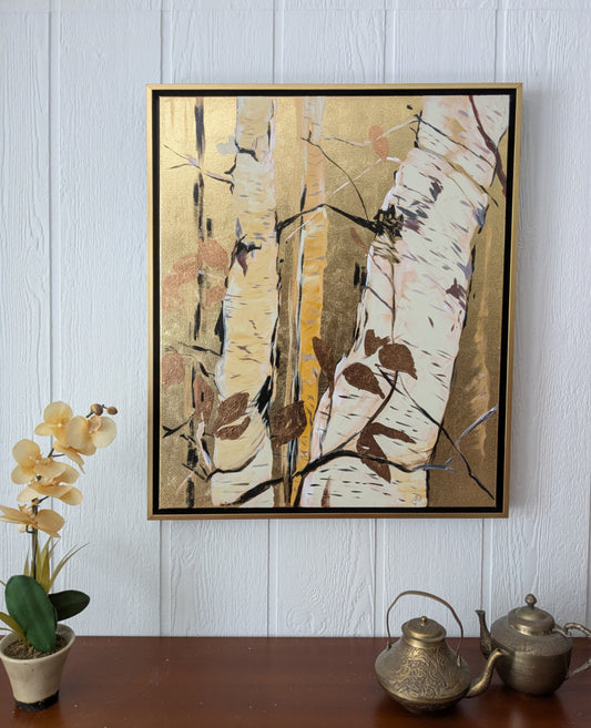 Framed abstract artwork on a wall with decorative items below